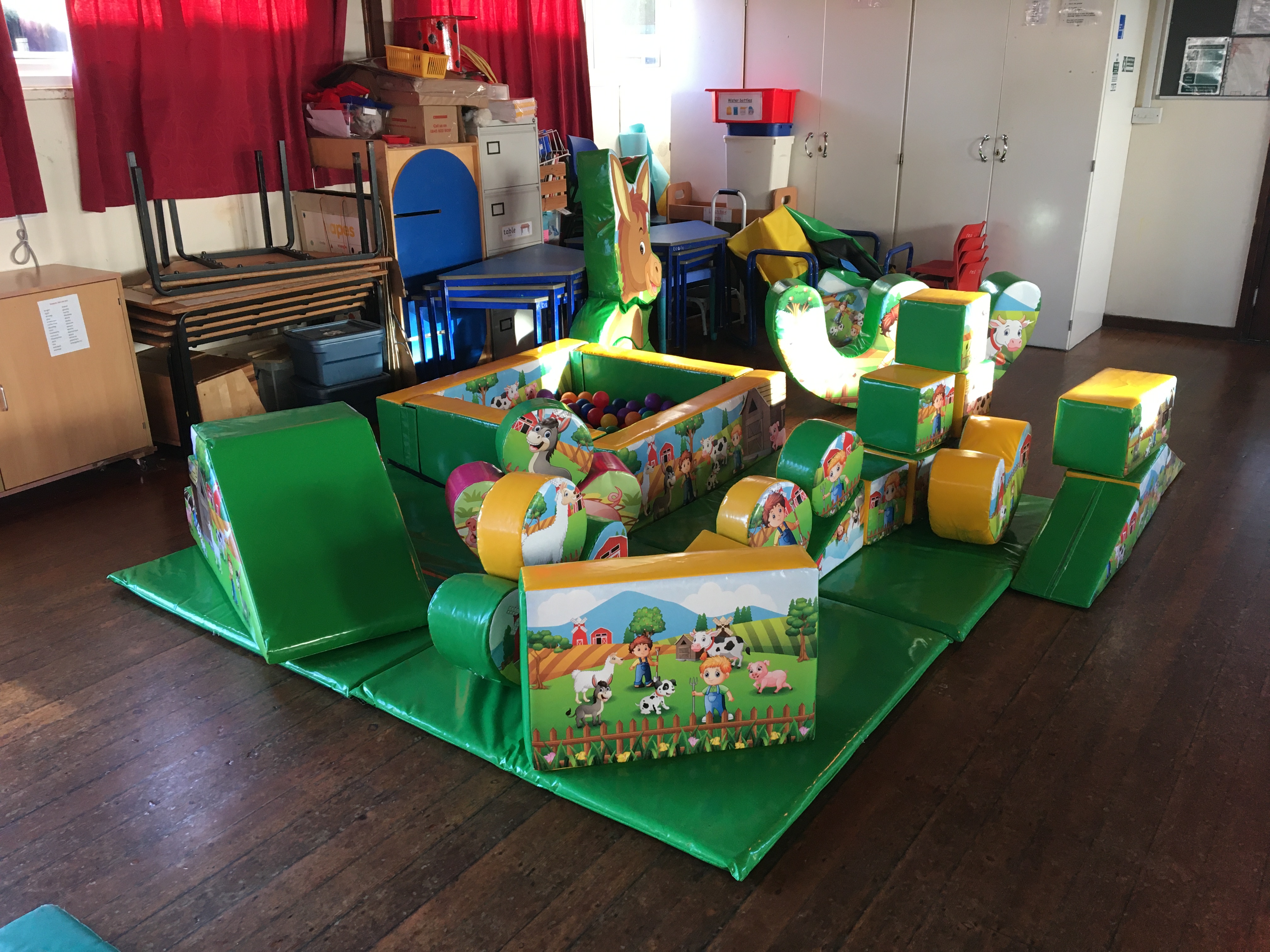 Assorted soft play items, with a ball pit. Farm themed. Can include a bouncy castle